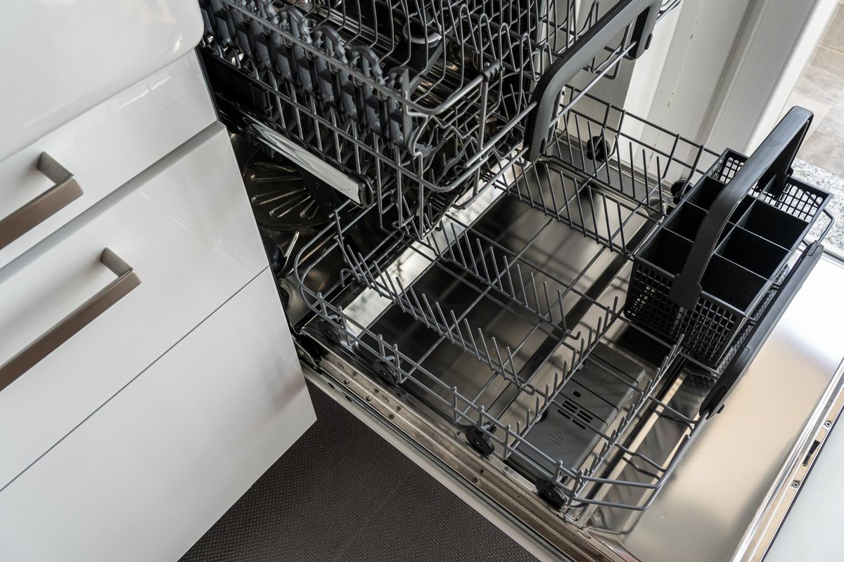 An open dishwasher in a kitchen