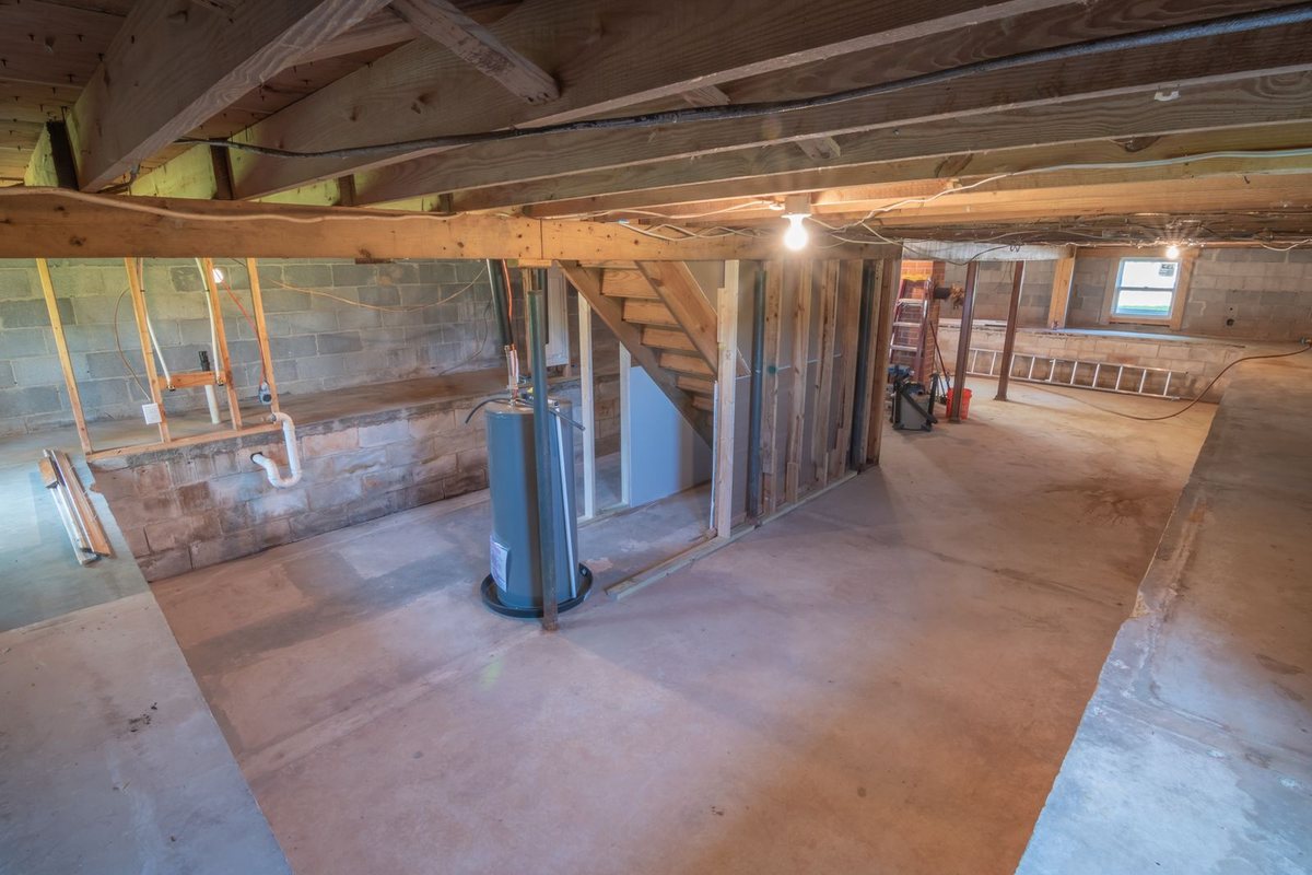 A basement utility area where a sump pump system is installed in Anchorage, AK