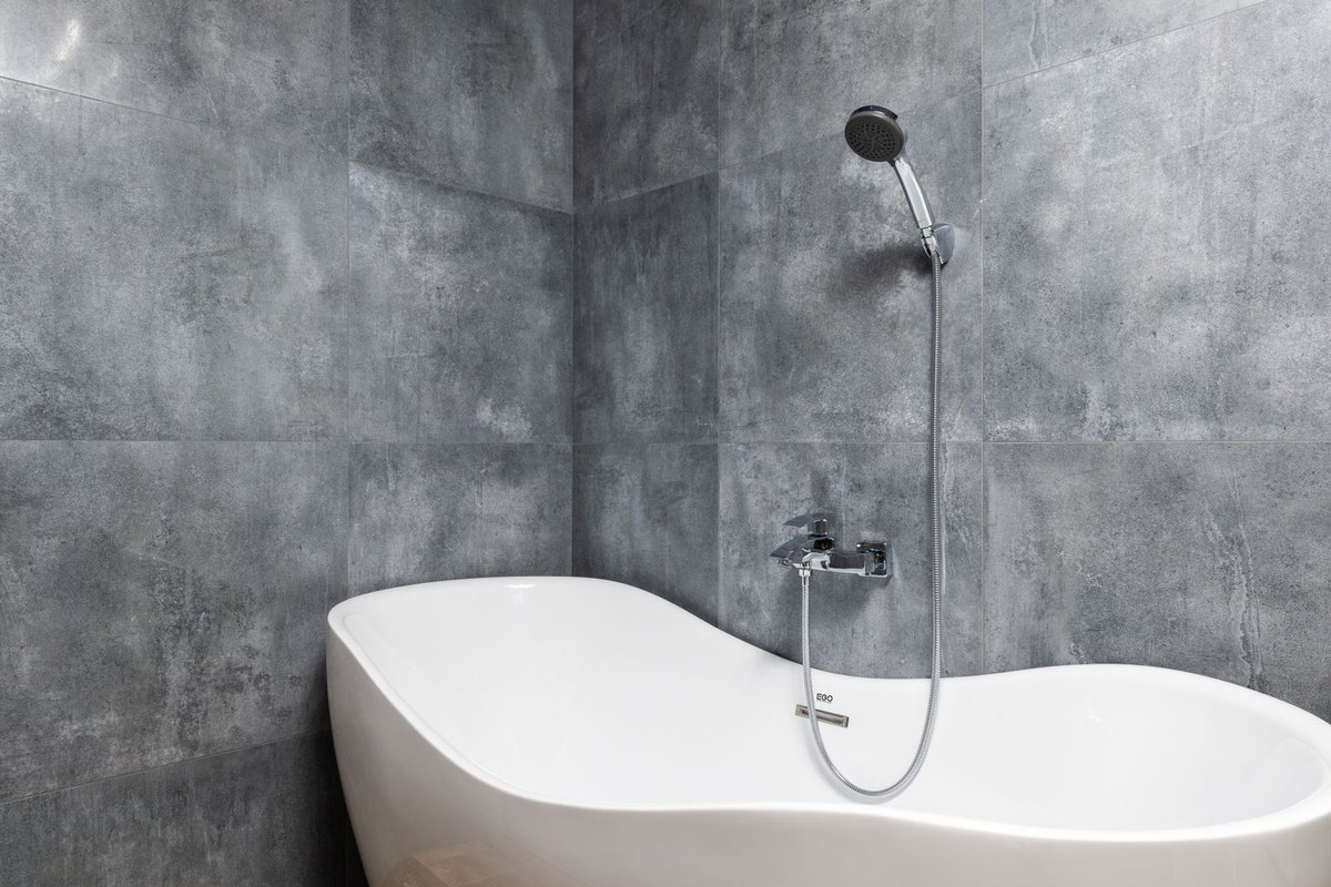 A clean white bathtub against a tiled wall in Anchorage, AK