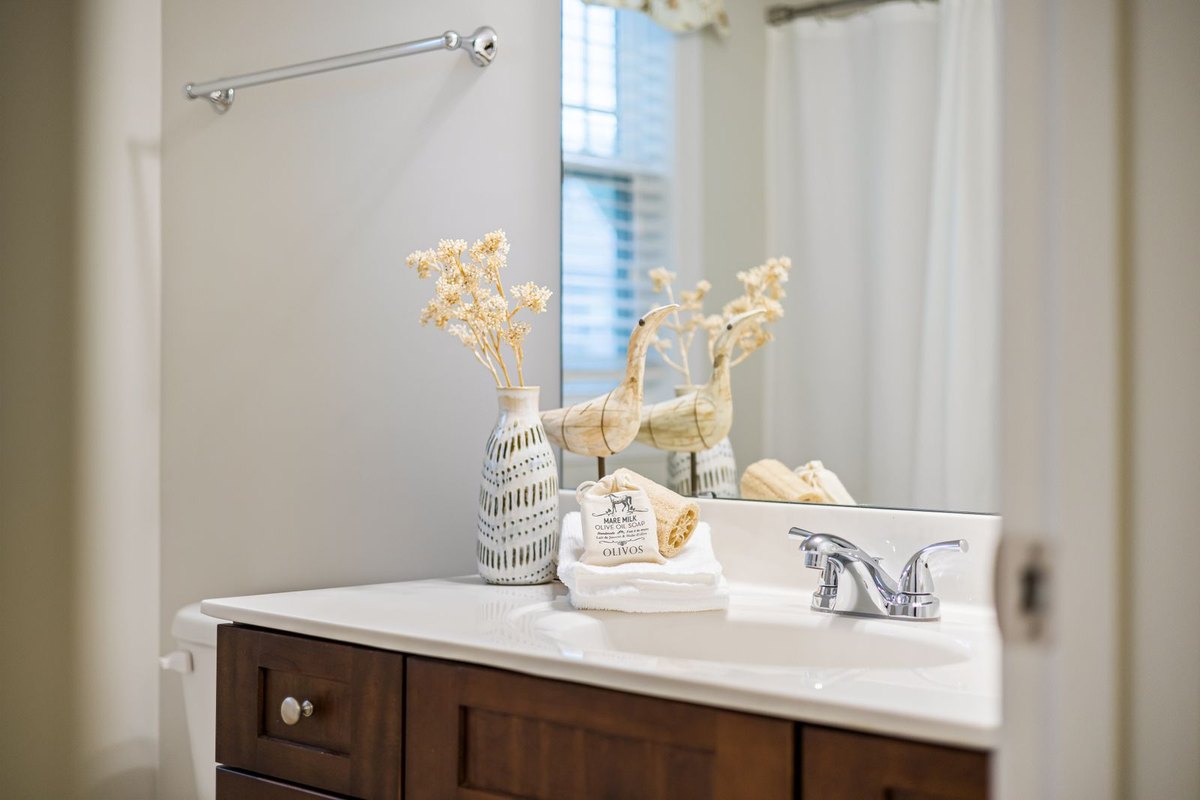 A wood vanity with a white countertop in Anchorage, AK