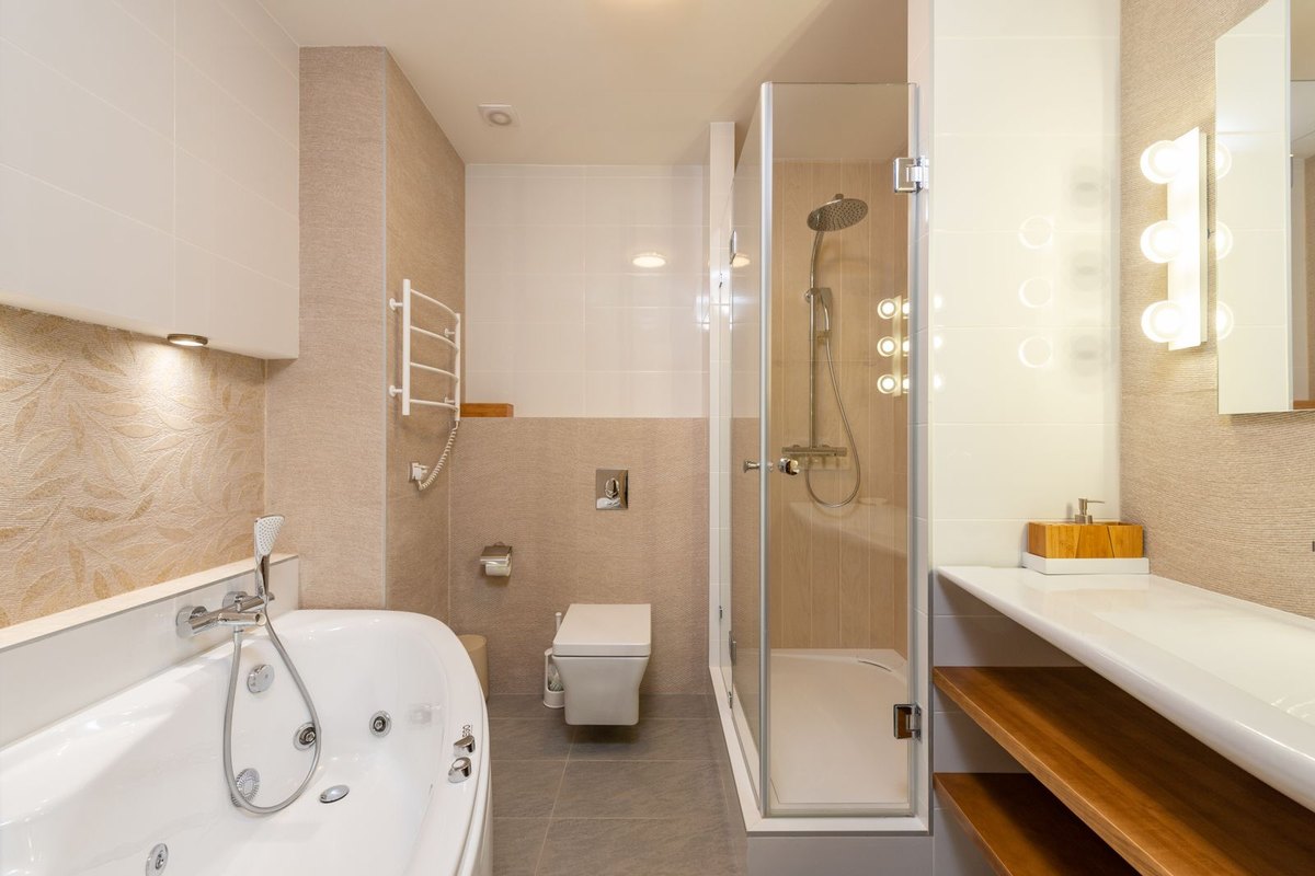 A bathroom with a built-in bathtub and glass shower in Anchorage, AK