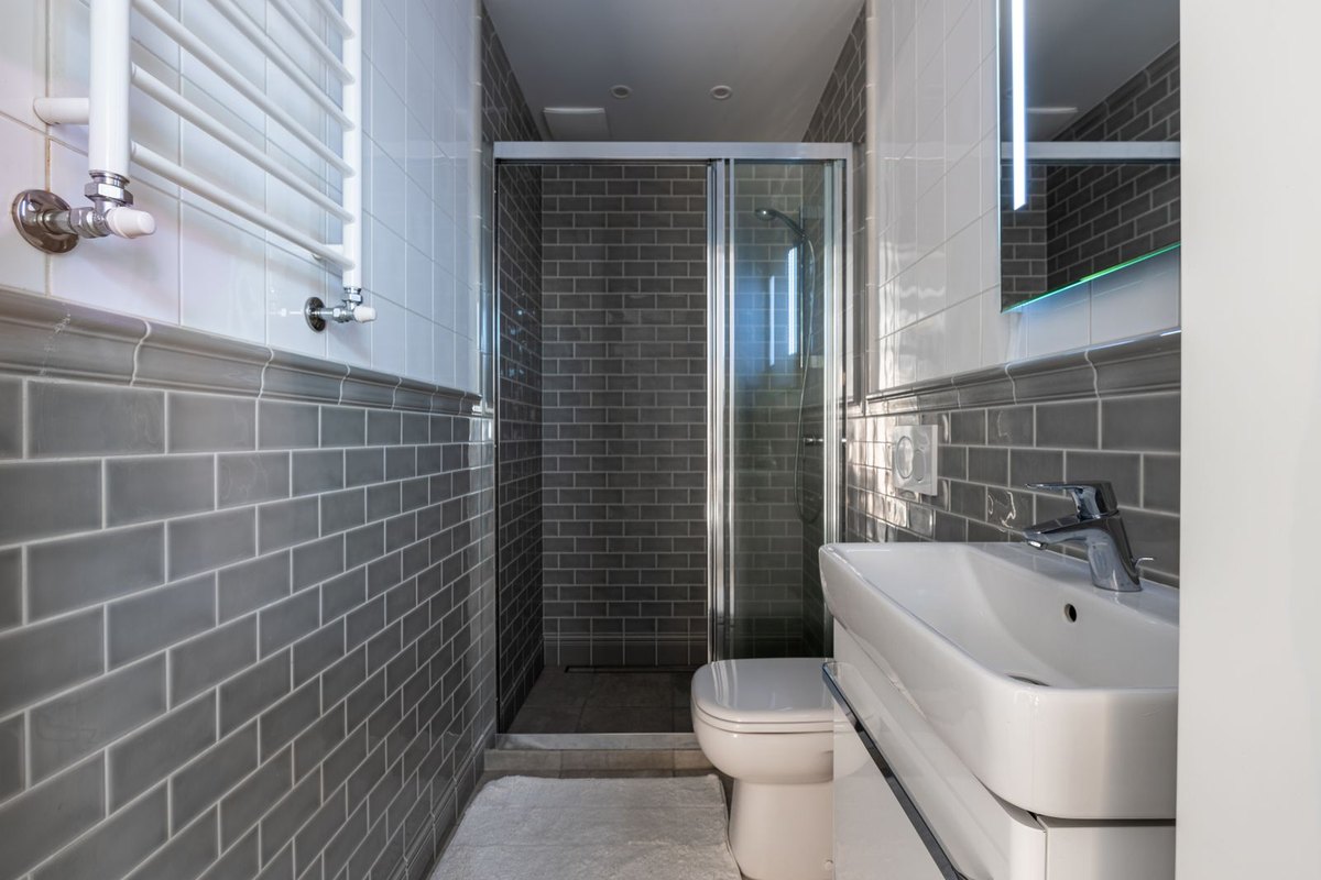 Gray subway-tiled bathroom walls and shower in Anchorage, AK