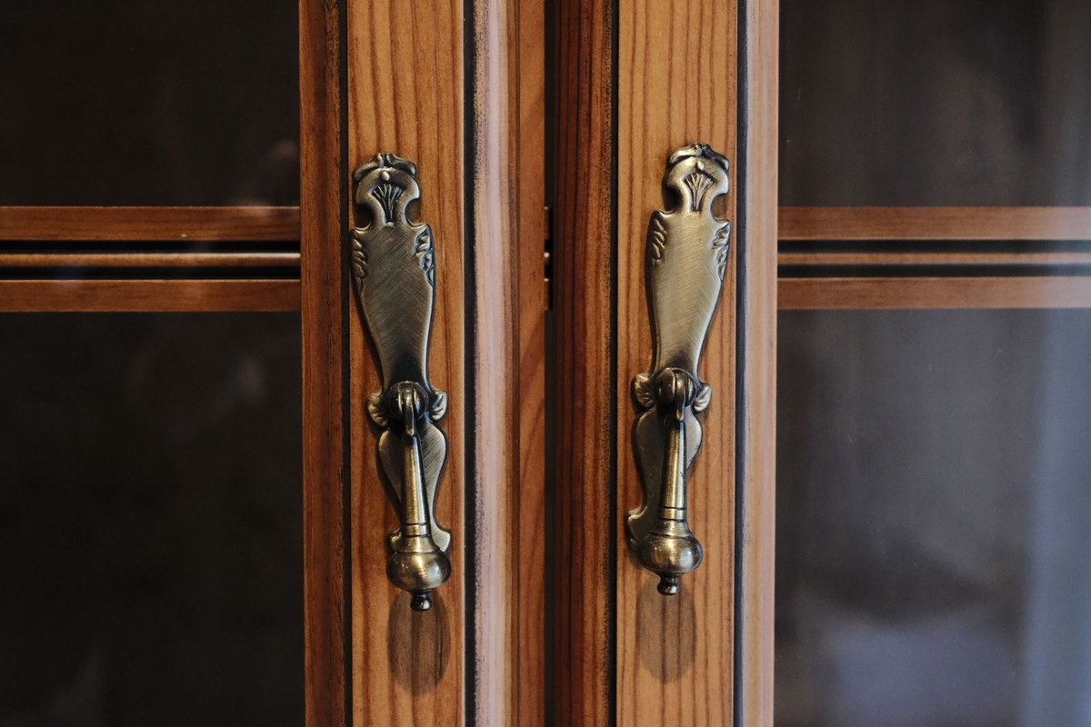 Close-up of brass handles on cabinet doors