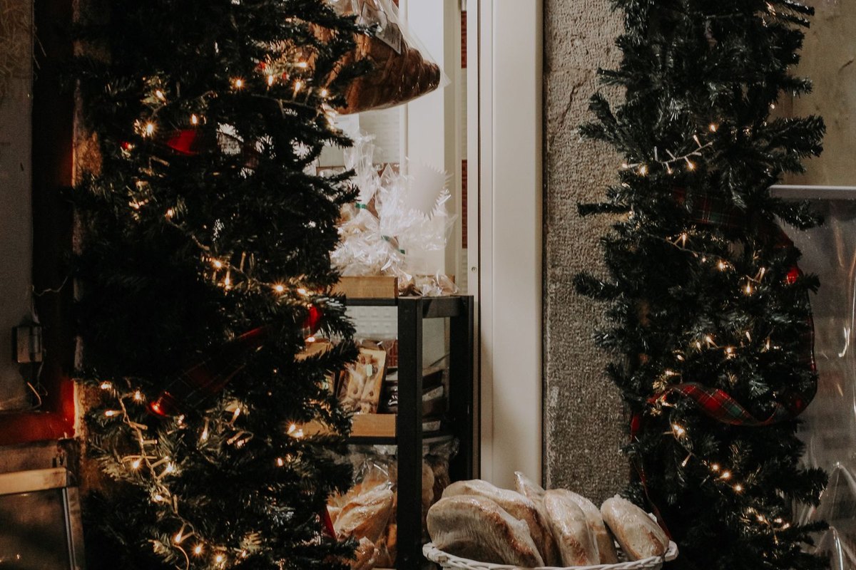 Storefront entrance decorated with Christmas trees and lights in Anchorage, AK