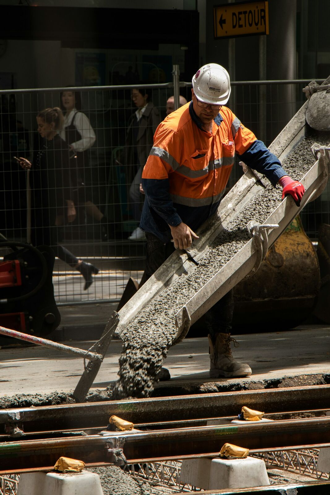 Crew pouring and finishing a concrete driveway