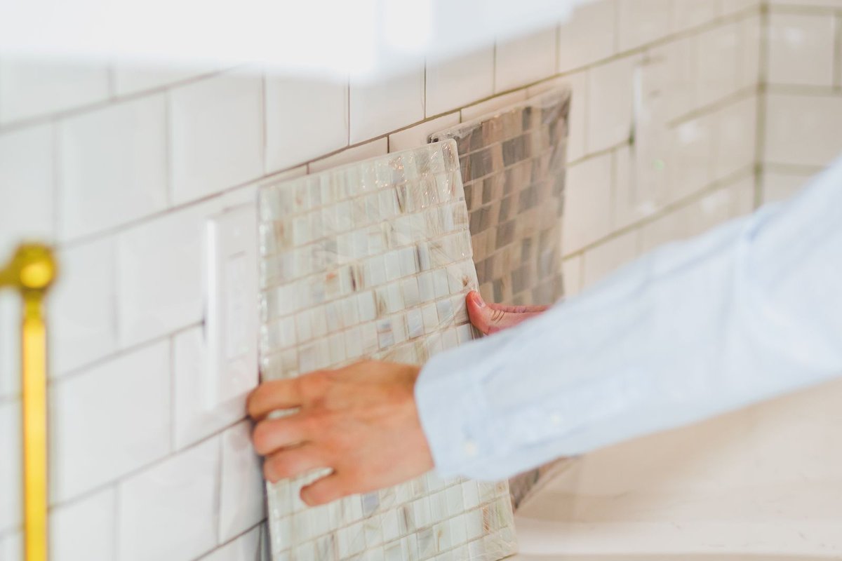Installer at work fitting finishes during a kitchen remodel in Anchorage