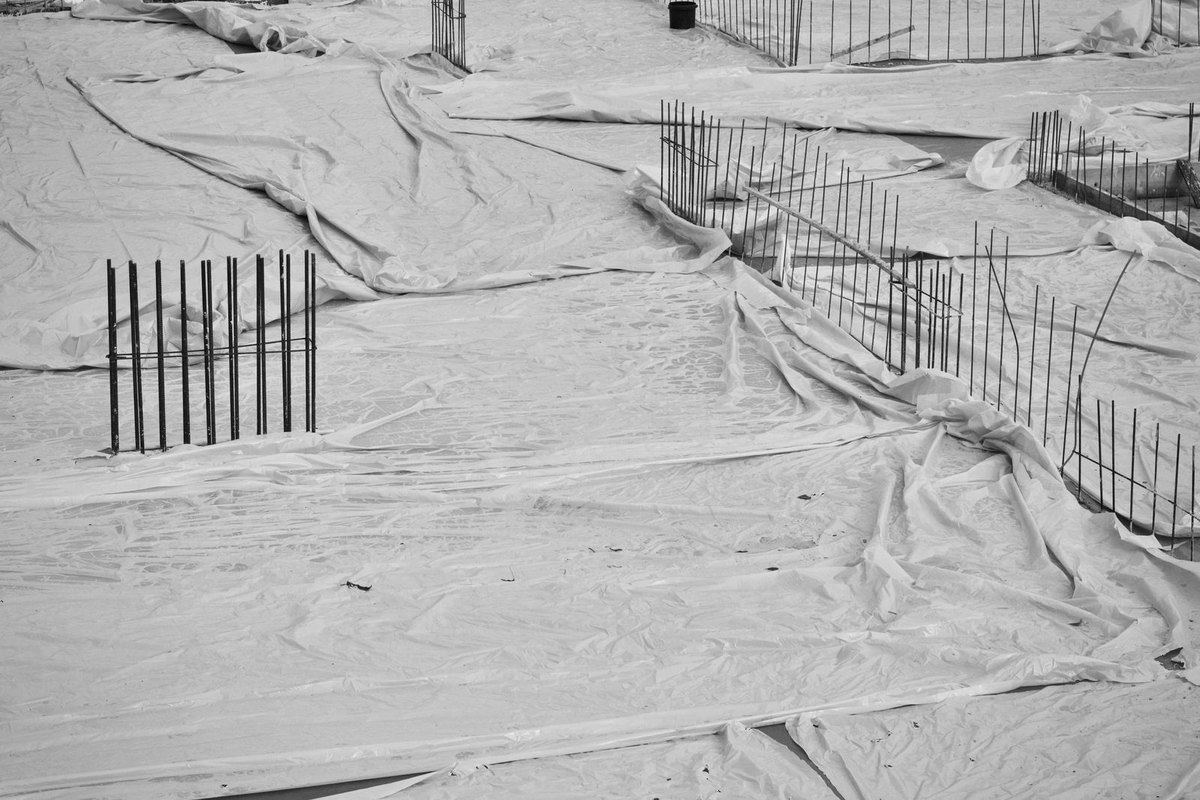 Building foundation area lined and covered with protective sheeting