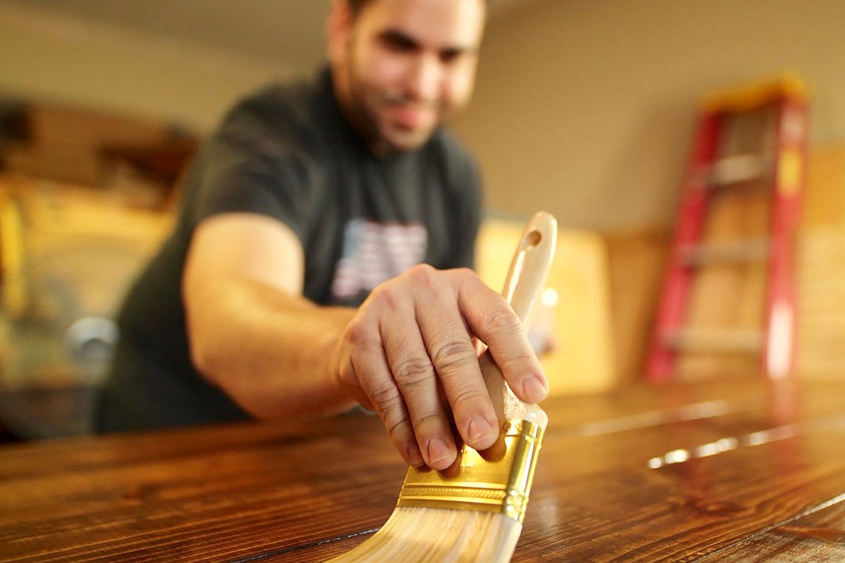 Applying a protective finish to wood with a brush