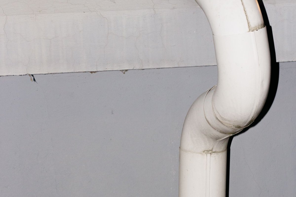 A length of drainage pipe against a wall