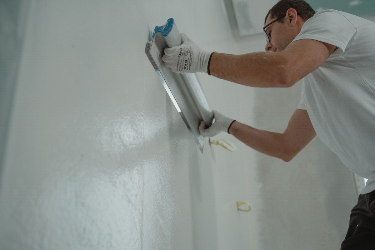 Drywall wall being skim-coated and finished smooth in Anchorage, AK