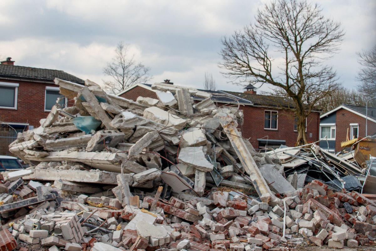 Piles of concrete and brick debris from a demolition in a residential area