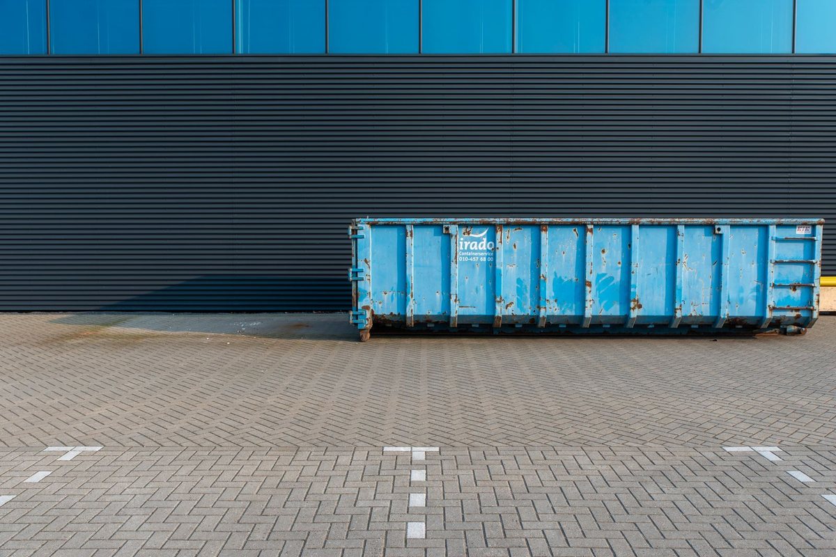 Roll-off dumpster container on a paved lot in Anchorage, AK