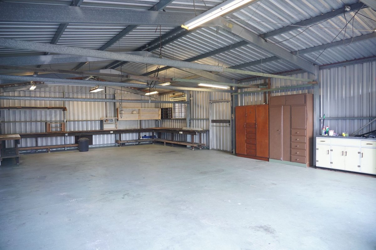 A clean garage with a clear floor and wall storage cabinets in Anchorage