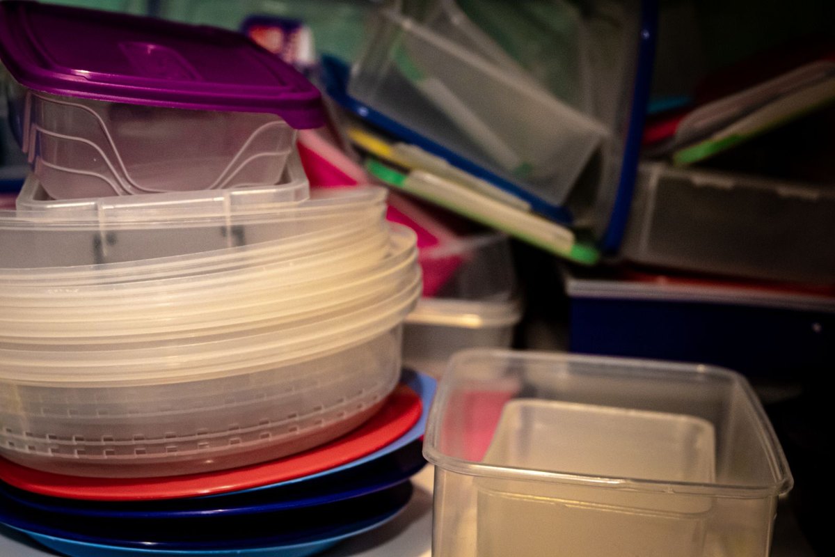 Stacked storage containers — the kind an overhead rack lifts up off the garage floor