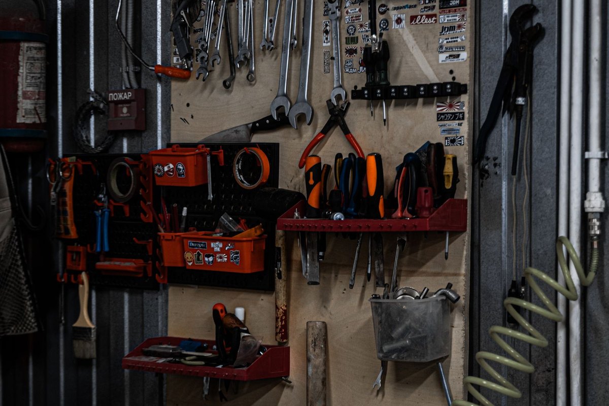 Tools hung in order on a garage wall organizer
