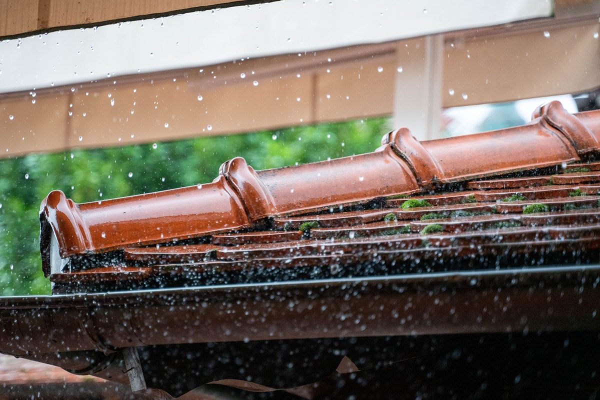 Rainwater running off a tiled residential roofline in Anchorage, AK