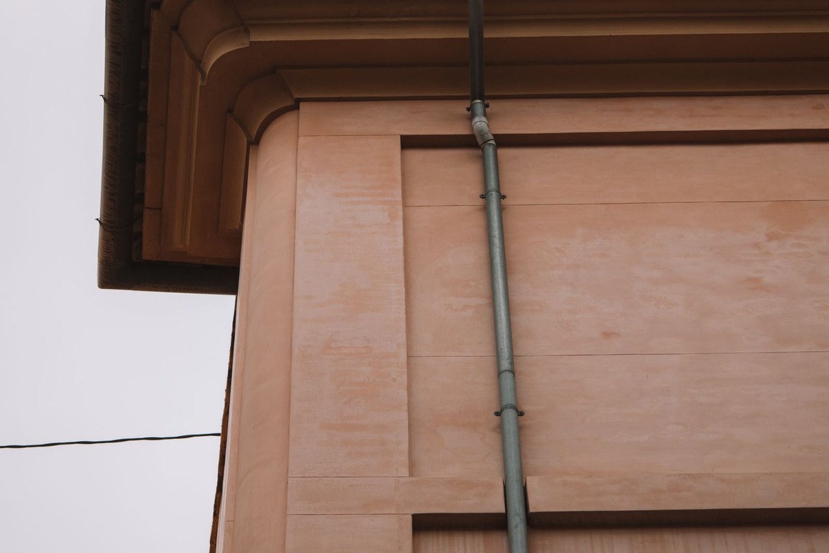 Downspout carrying rainwater down the wall of a home