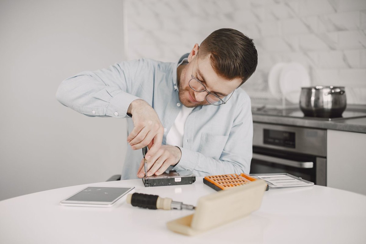 A person making a small home repair with hand tools