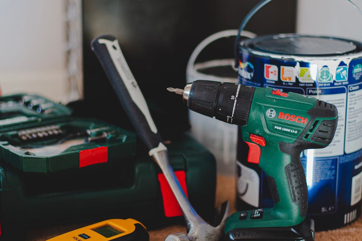 A drill, level and other tools ready for a job