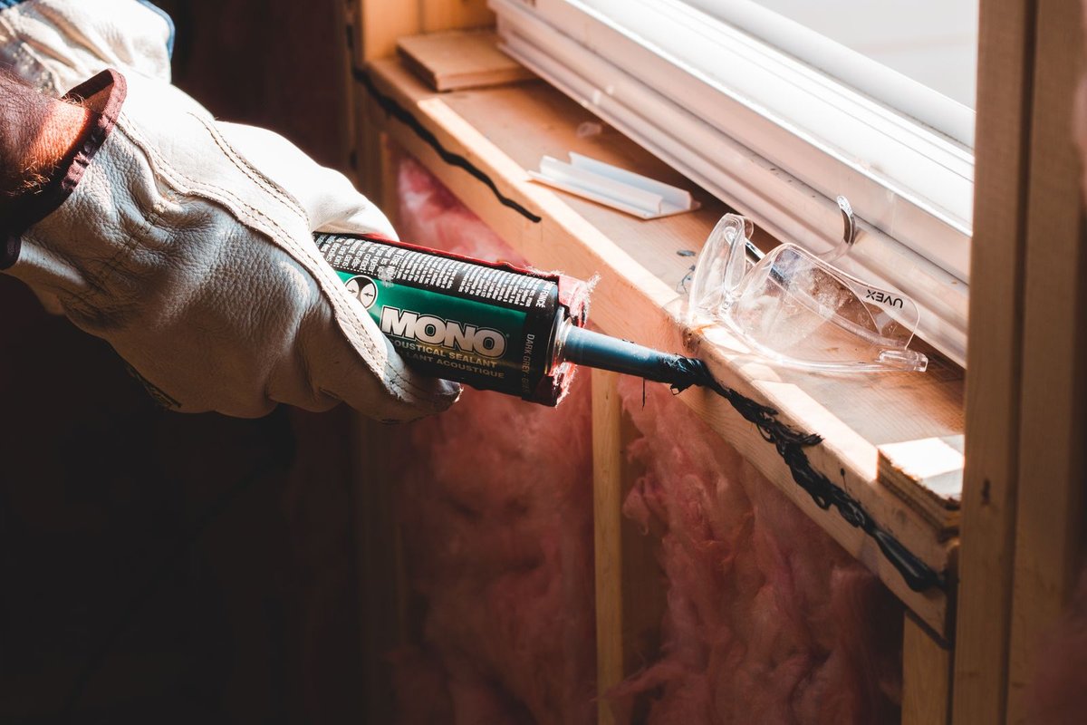 Sealing gaps around a window before insulating a Anchorage home