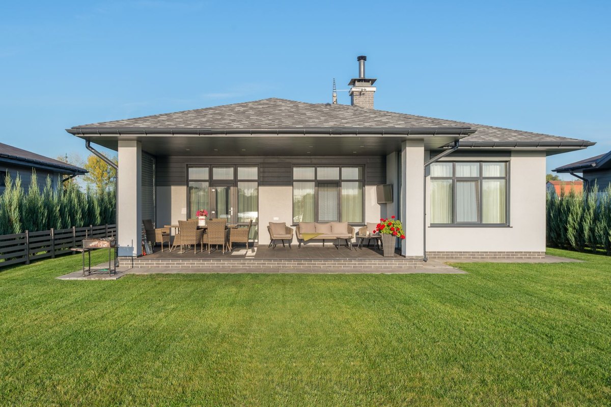 A manicured green lawn beside a modern home in Anchorage, AK