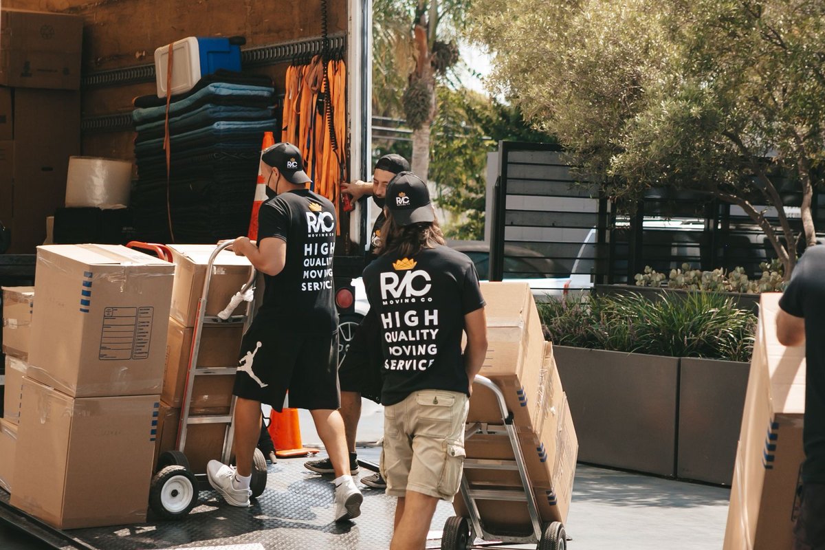 A moving crew loading boxes with a dolly on moving day in Anchorage, AK