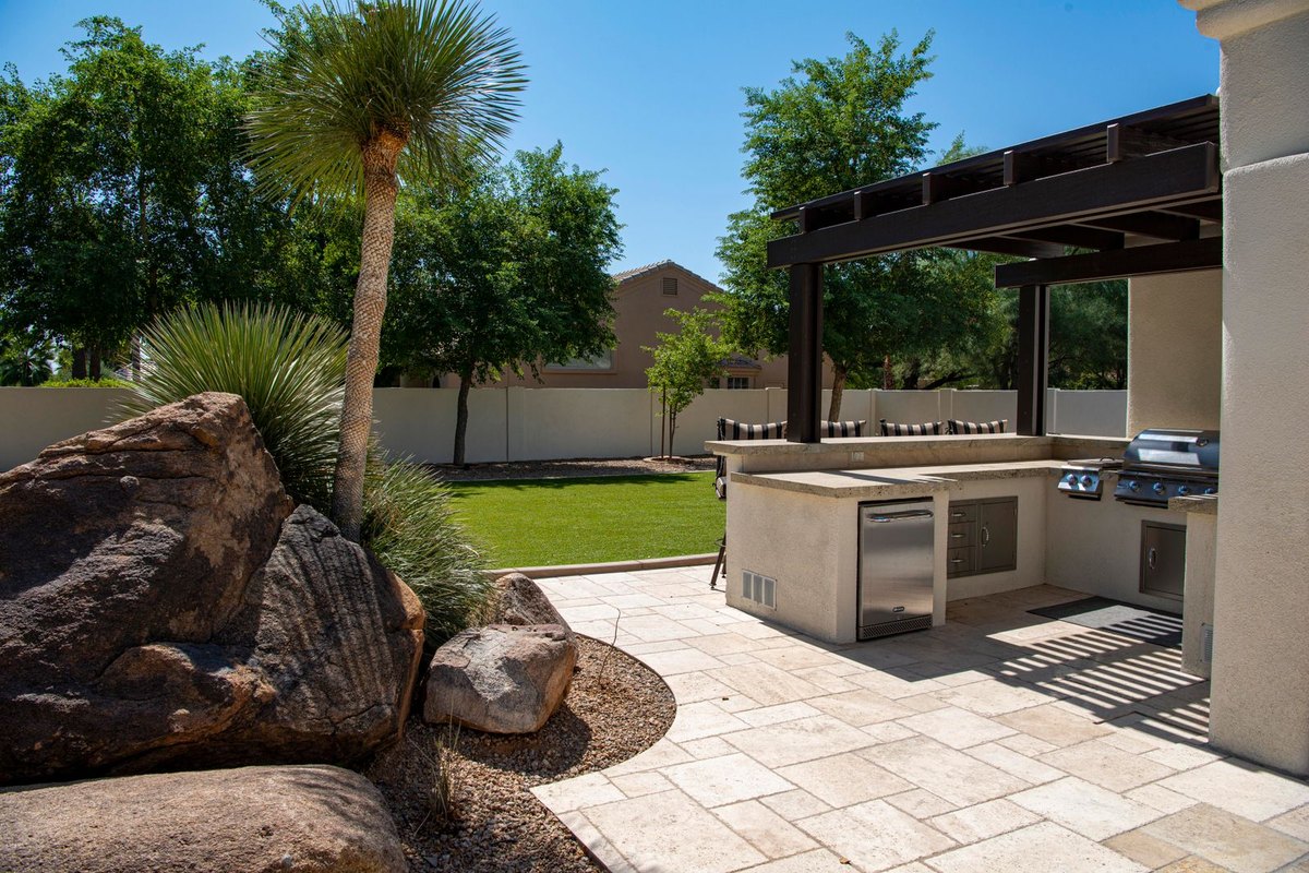 Finished outdoor kitchen with grill and counter on a patio in Anchorage, AK