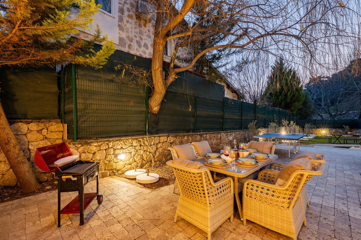 Outdoor living and dining space beside an outdoor kitchen in Anchorage