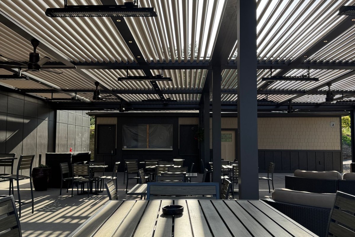 Slatted-roof pergola casting striped shadows over a patio in Anchorage, AK