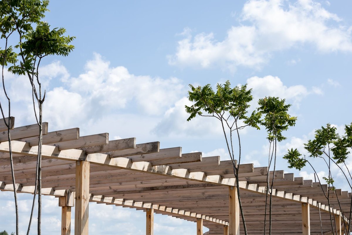 Stained wood pergola posts and beams in a backyard in Anchorage, AK