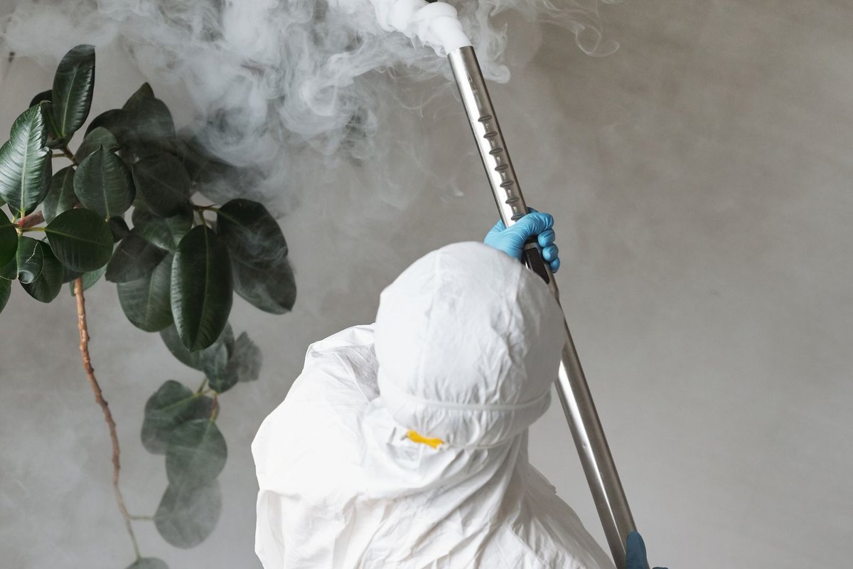 Pest control technician treating a home in Anchorage, AK