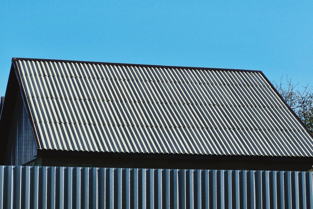 Corrugated metal roof on a building under a clear sky