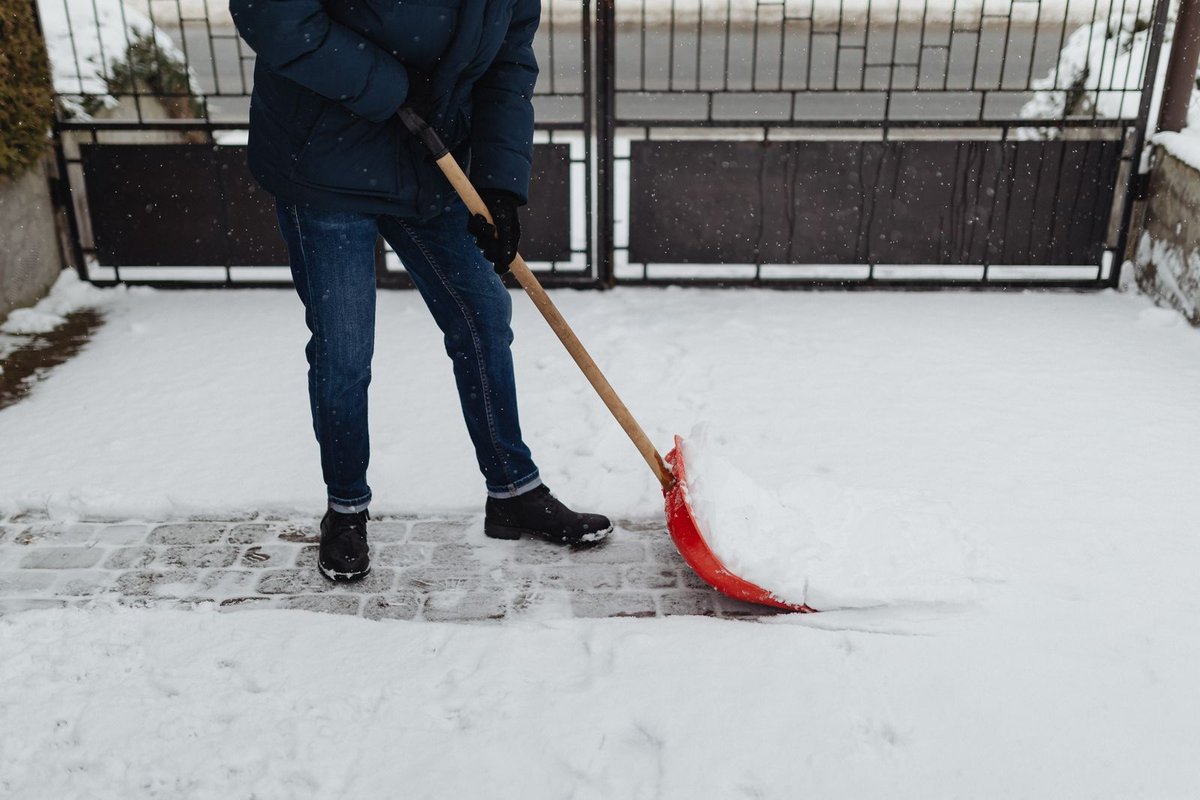 Shoveling snow from a sidewalk and walkway in Anchorage, AK