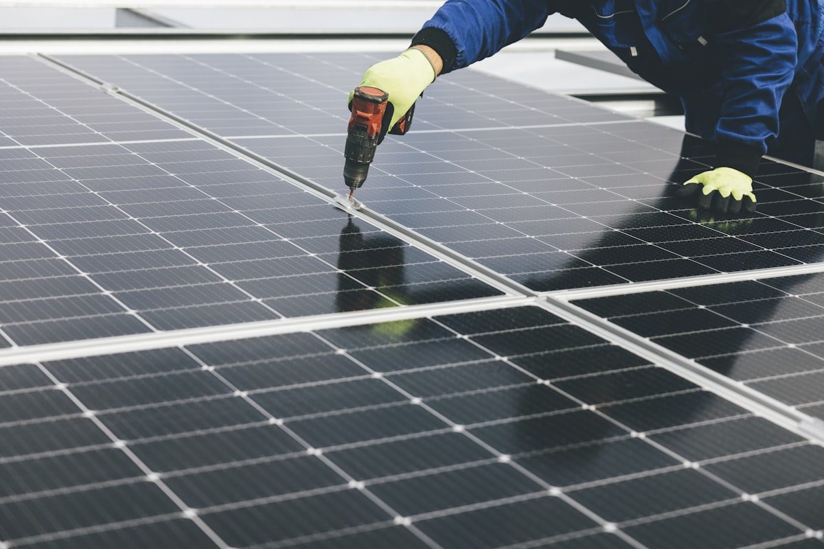 Technician inspecting and maintaining solar panels in Anchorage, AK