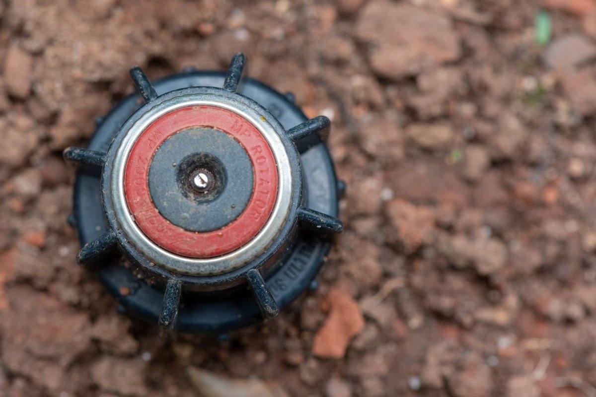 Close-up of a sprinkler head, the kind checked and adjusted during seasonal service in Anchorage