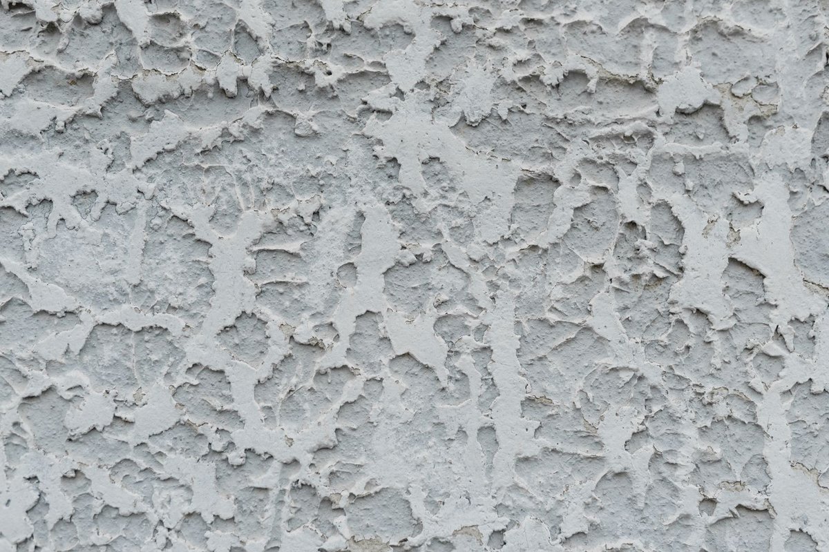 Weathered, aged stucco wall surface in Anchorage, AK