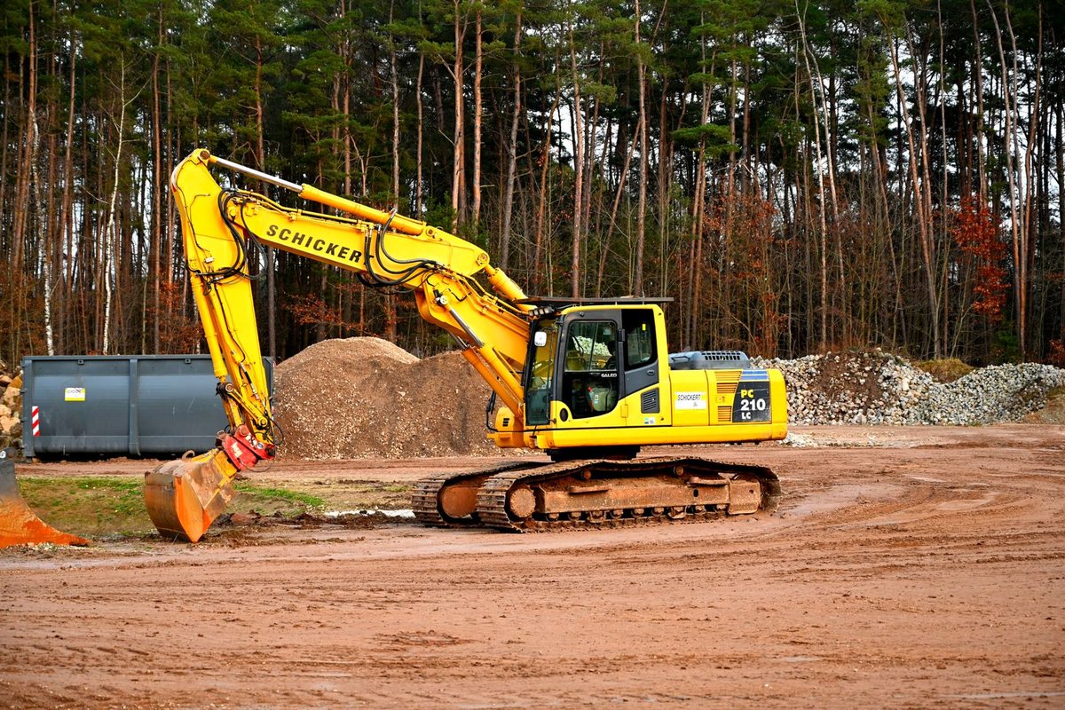 Excavator clearing a site where stumps are being removed in Anchorage, AK