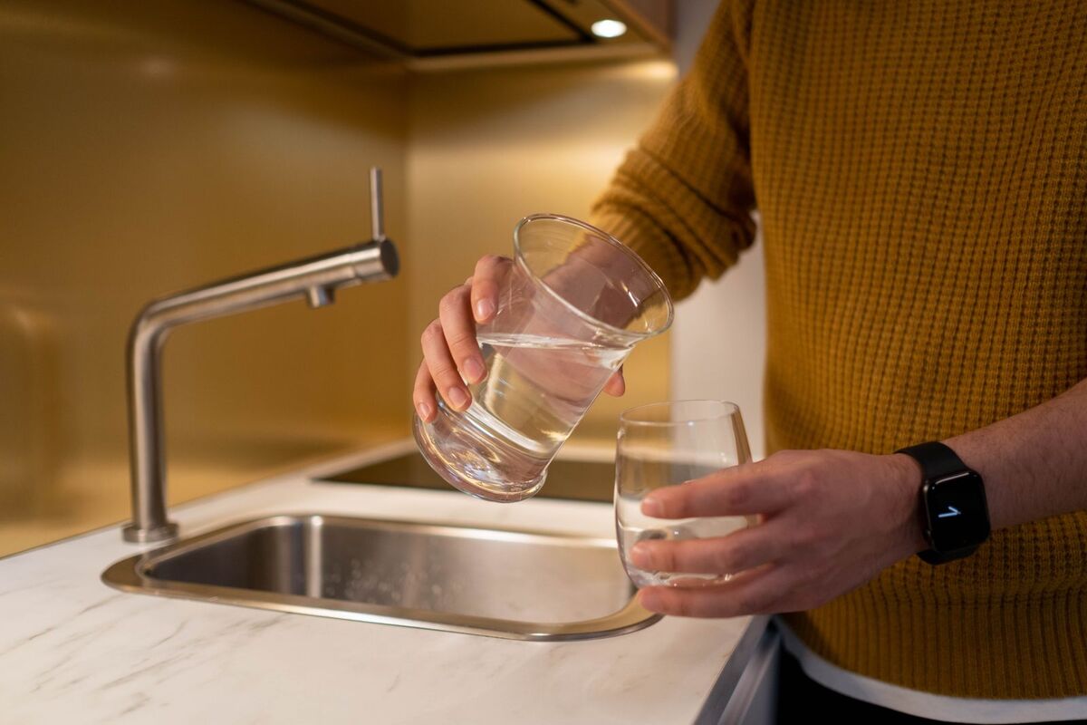 Clean drinking water poured at a kitchen sink