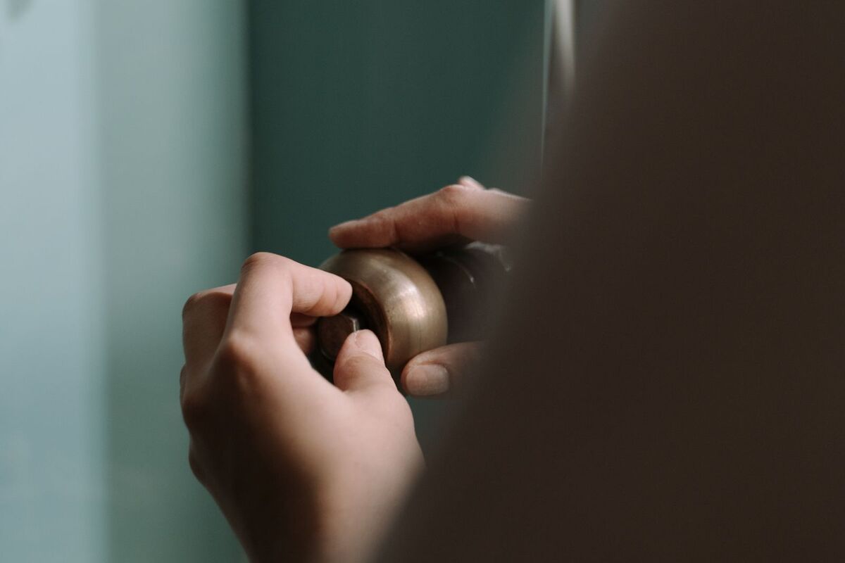 Hands working on a plumbing fitting