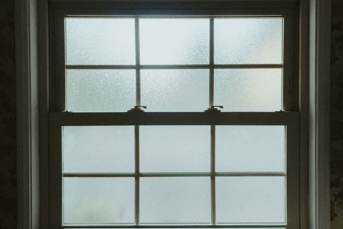 A frosted privacy-glass window or door panel in Anchorage, AK